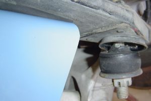 Compressed spring & spring bolt on C4 Corvette rear suspension